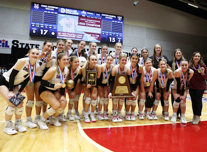 Comal Davenport poses with the UIL Class 4A state volleyball title trophy on Saturday in Garland.